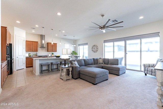 living room with light carpet and ceiling fan