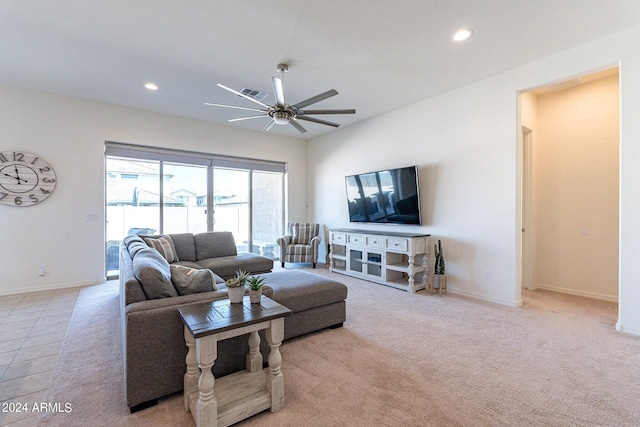 carpeted living room with ceiling fan