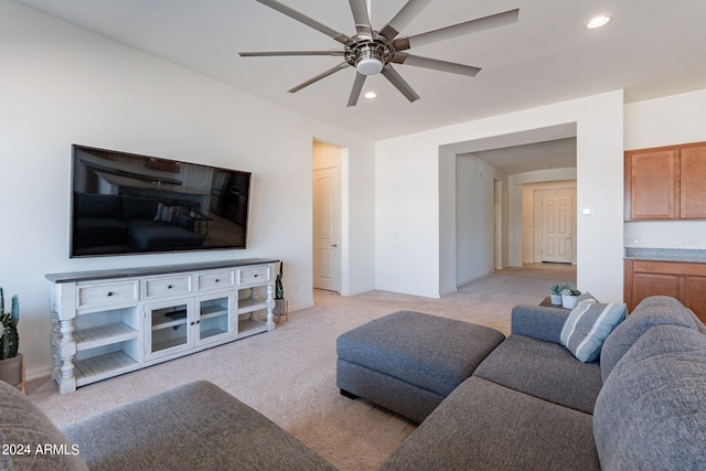 carpeted living room featuring ceiling fan