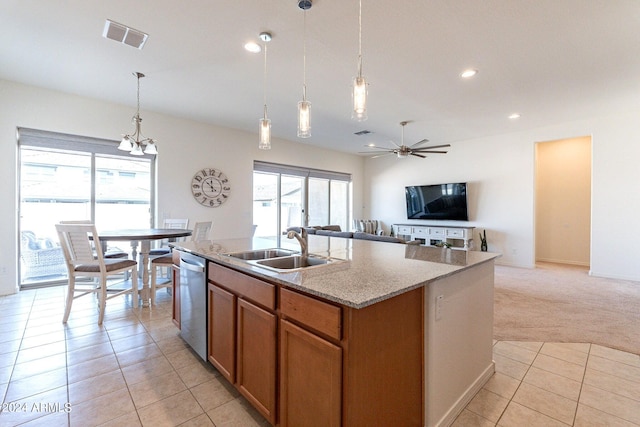 kitchen with dishwasher, a center island with sink, sink, decorative light fixtures, and light colored carpet