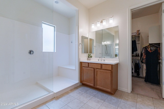 bathroom featuring a shower, vanity, and tile patterned floors