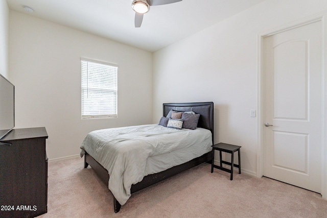 bedroom with ceiling fan and light carpet