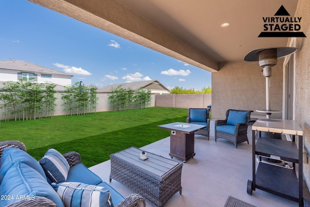 view of patio / terrace with an outdoor living space with a fire pit