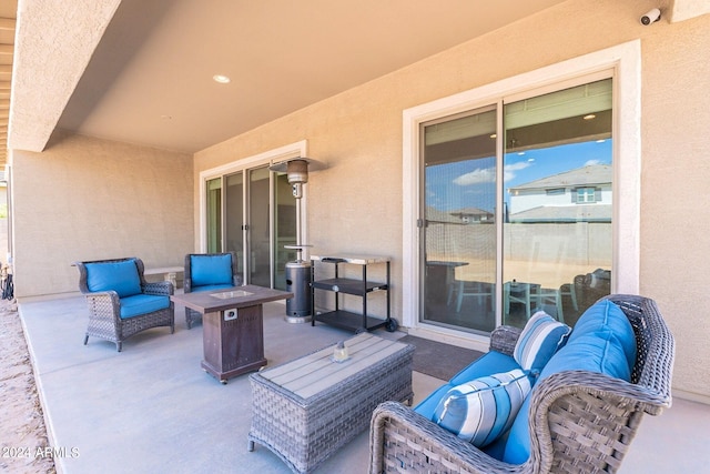 view of patio / terrace featuring an outdoor living space with a fire pit