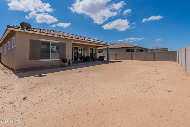 rear view of house featuring a patio