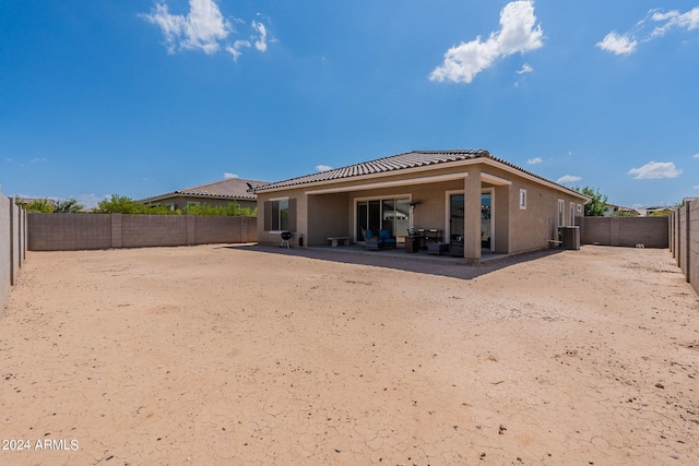 back of house featuring central air condition unit and a patio