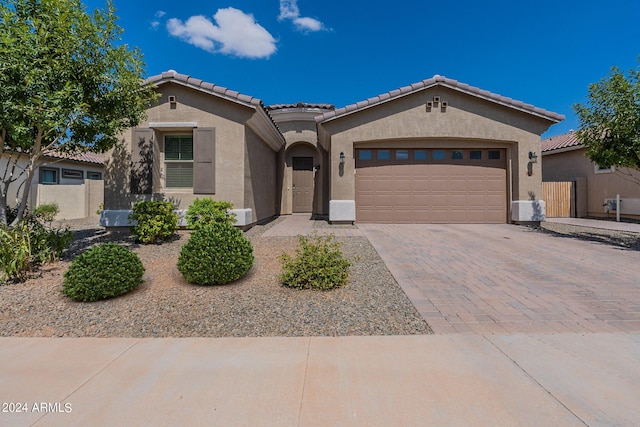 mediterranean / spanish-style home with a garage