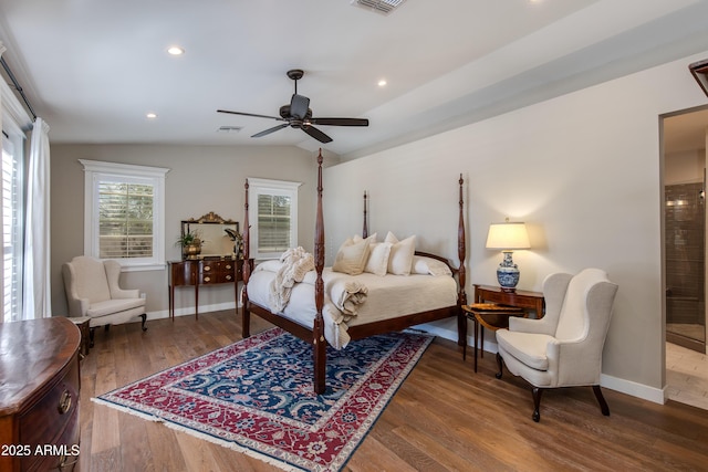 bedroom with baseboards, visible vents, wood finished floors, vaulted ceiling, and recessed lighting