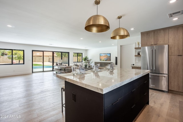 kitchen featuring visible vents, modern cabinets, high quality fridge, open floor plan, and open shelves