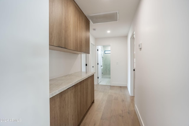 corridor with recessed lighting, visible vents, light wood-style flooring, and baseboards