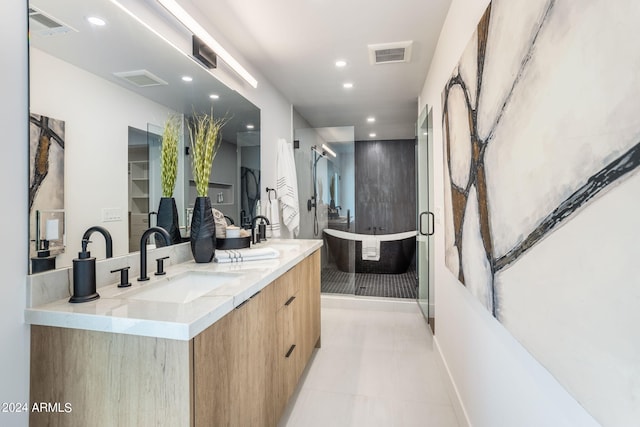 bathroom with double vanity, visible vents, a sink, and recessed lighting