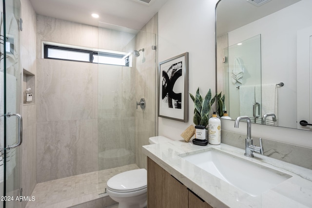 bathroom featuring a stall shower, visible vents, toilet, vanity, and recessed lighting