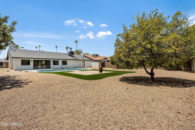 back of property featuring a fenced in pool, a patio area, and a fenced backyard