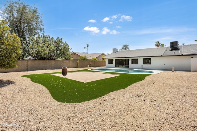 exterior space with a fenced in pool, central AC, a patio area, and a fenced backyard