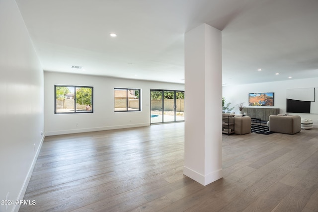 interior space with plenty of natural light, wood finished floors, and recessed lighting