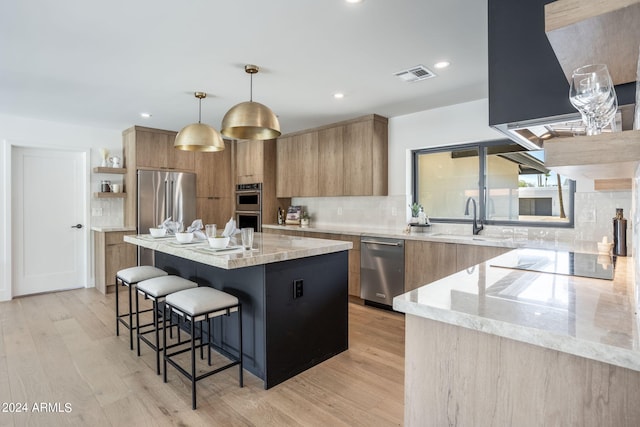 kitchen with visible vents, modern cabinets, a breakfast bar, stainless steel appliances, and open shelves