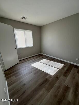 empty room with dark hardwood / wood-style floors