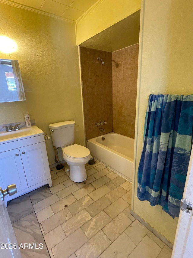 full bathroom with ornamental molding, toilet, vanity, and tiled shower / bath