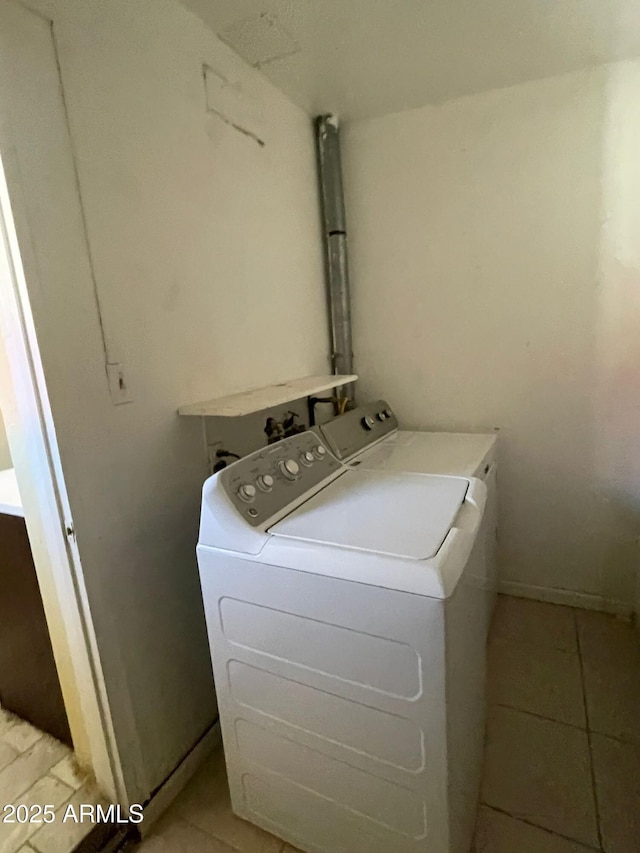 laundry area with light tile patterned flooring and separate washer and dryer