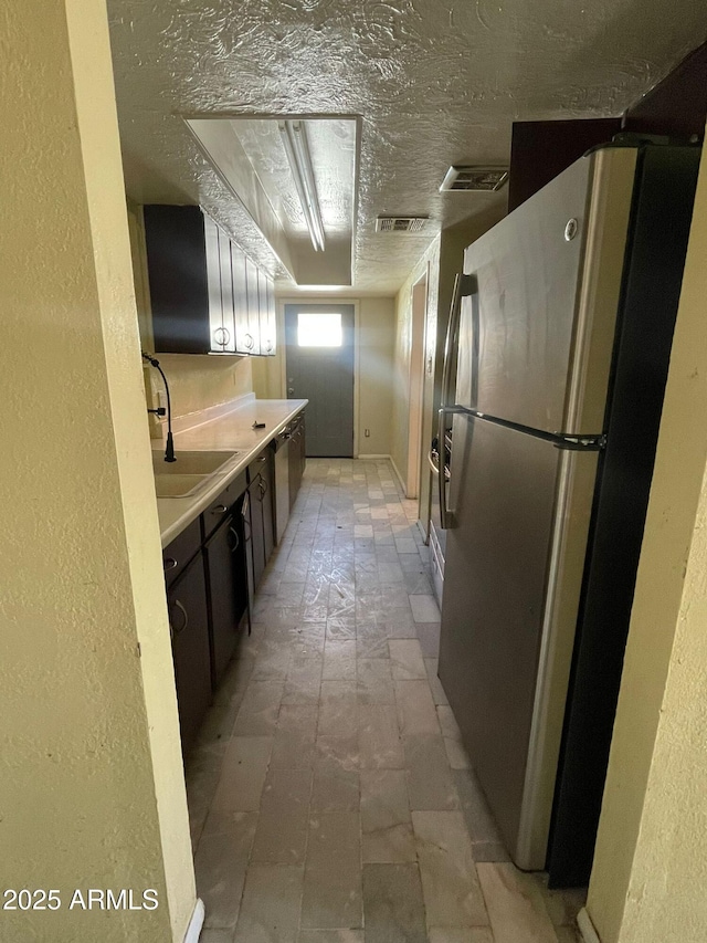 kitchen with stainless steel refrigerator and sink