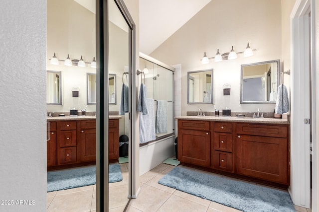 bathroom with tile patterned floors, lofted ceiling, an enclosed shower, and vanity