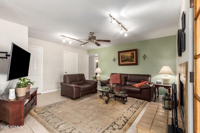 living room with light tile patterned floors, track lighting, and ceiling fan