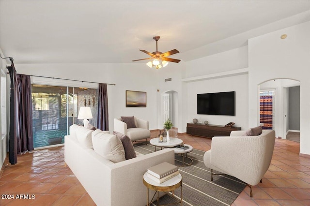 living room featuring tile patterned flooring, ceiling fan, and lofted ceiling