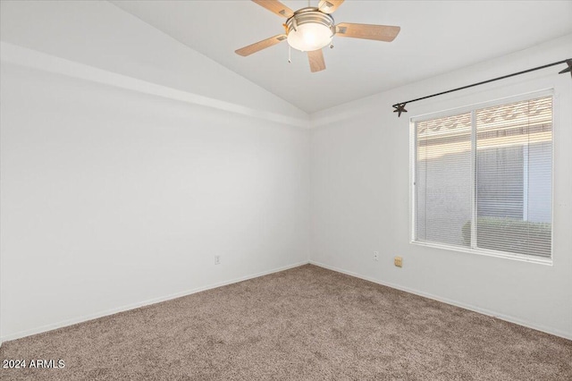 empty room featuring ceiling fan, carpet floors, and vaulted ceiling