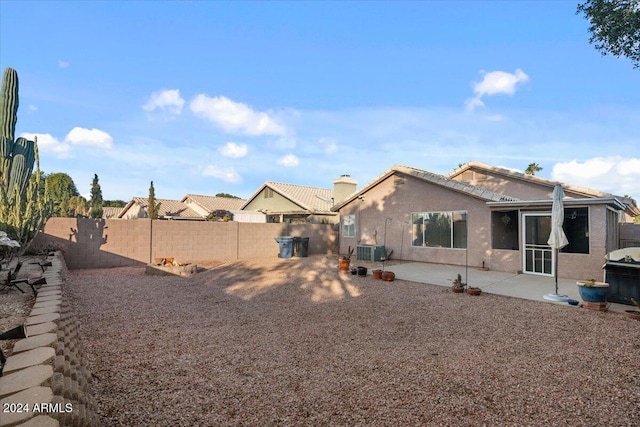 back of property with a patio area and central AC unit