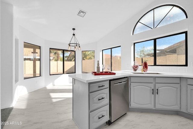 kitchen featuring pendant lighting, sink, gray cabinetry, a notable chandelier, and stainless steel dishwasher