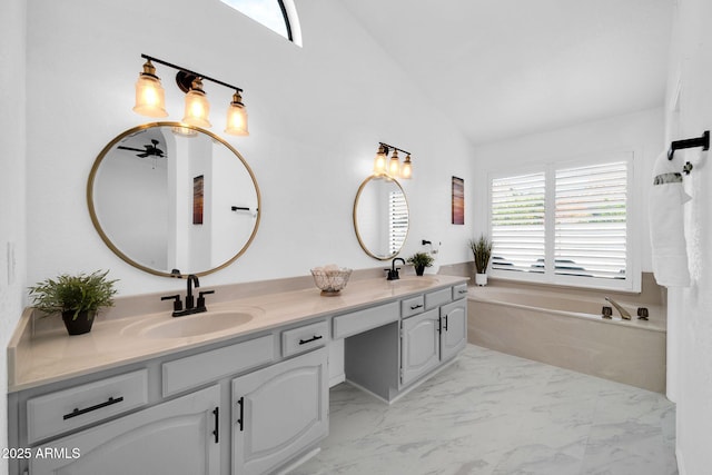 bathroom featuring vanity, vaulted ceiling, and a tub