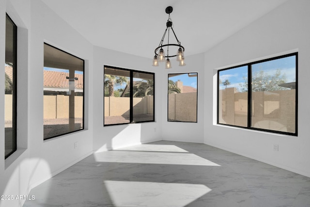 sunroom / solarium with an inviting chandelier and a healthy amount of sunlight