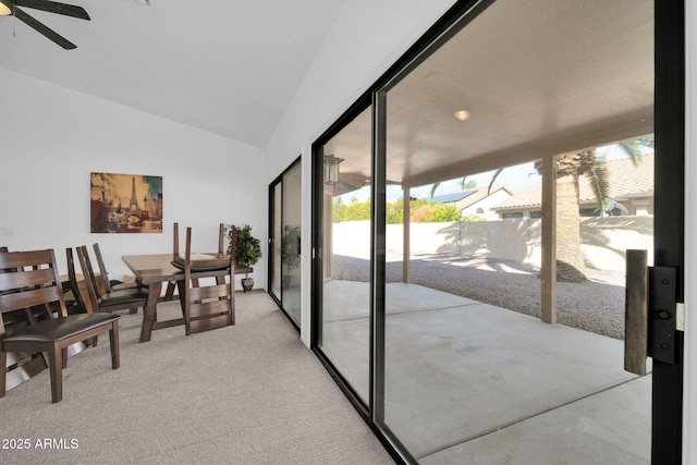 interior space with ceiling fan and vaulted ceiling