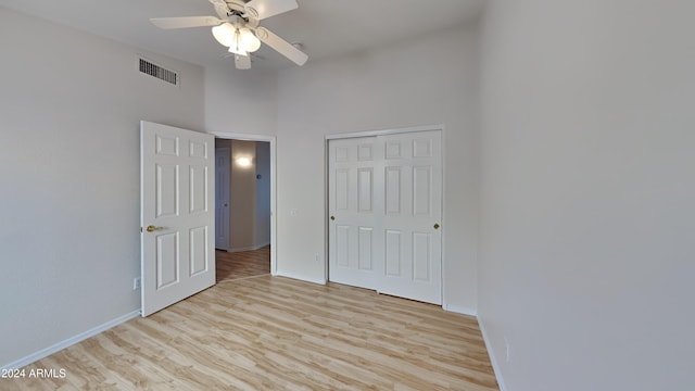 unfurnished bedroom featuring a closet, ceiling fan, and light hardwood / wood-style flooring