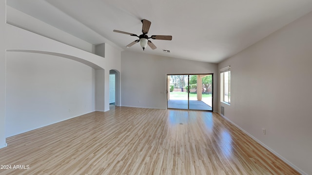 empty room with ceiling fan, high vaulted ceiling, and light wood-type flooring