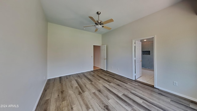 unfurnished bedroom with ensuite bathroom, ceiling fan, and light hardwood / wood-style floors