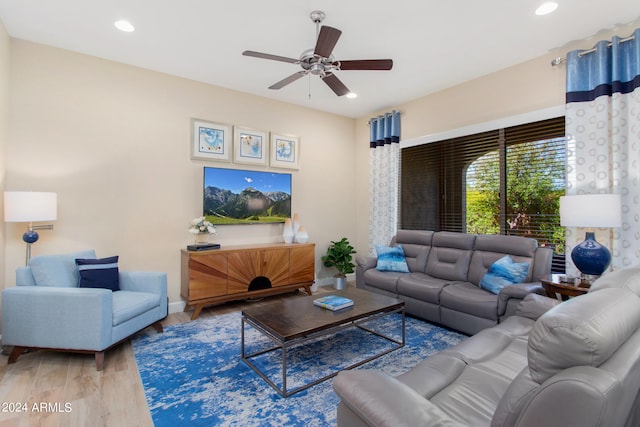 living room featuring ceiling fan and light hardwood / wood-style flooring