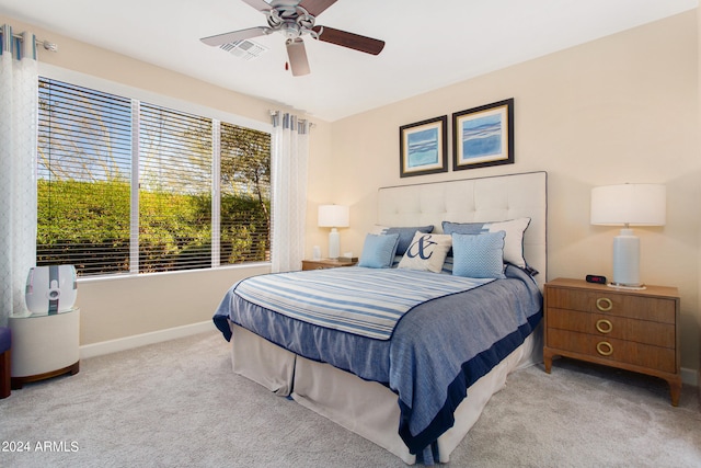 bedroom with light carpet and ceiling fan