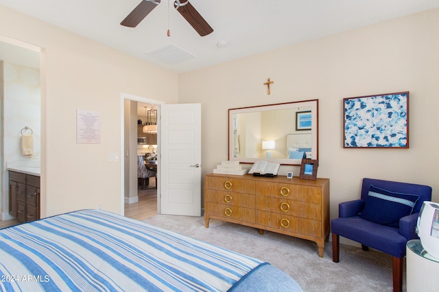 carpeted bedroom featuring ceiling fan and ensuite bath