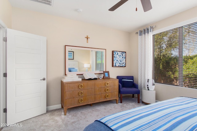 bedroom featuring light carpet and ceiling fan