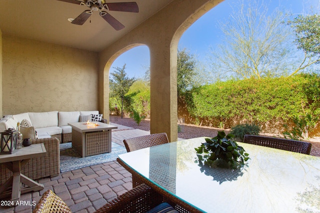 view of patio / terrace with ceiling fan and an outdoor living space