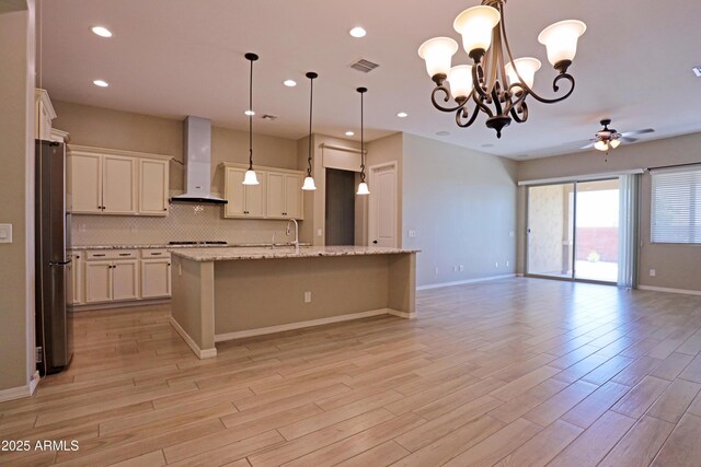 2811 S Jeffry St, Gilbert, AZ 85295 - kitchen with wall chimney range hood, open floor plan, ceiling fan, light wood-type flooring, and recessed lighting