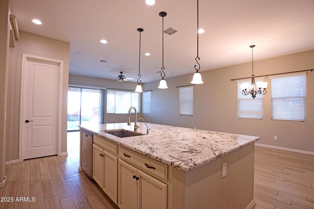 2811 S Jeffry St, Gilbert, AZ 85295 - kitchen featuring light wood-style flooring, ceiling fan, light stone countertops, an island with sink, and recessed lighting