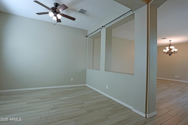 2811 S Jeffry St, Gilbert, AZ 85295 - spare room with light wood-type flooring, ceiling fan, and a chandelier