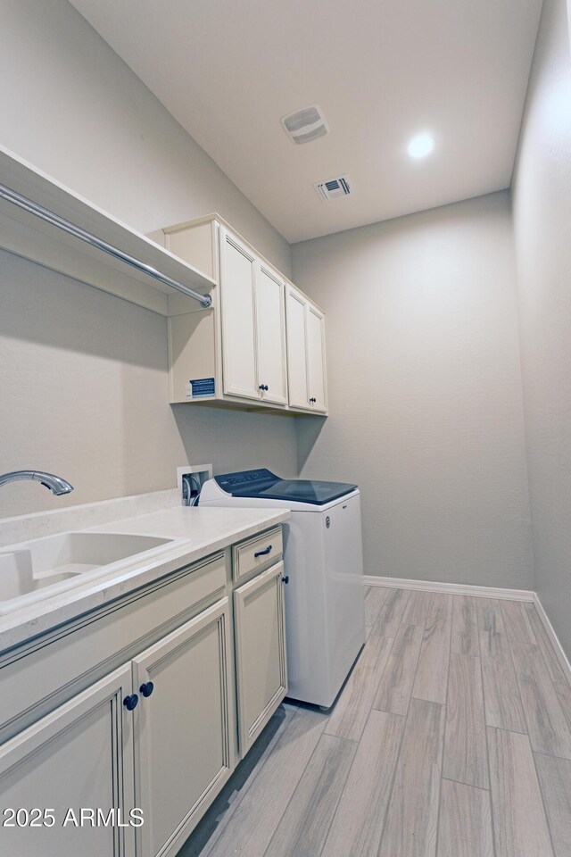 2811 S Jeffry St, Gilbert, AZ 85295 - washroom with cabinet space, light wood-type flooring, and washer / dryer