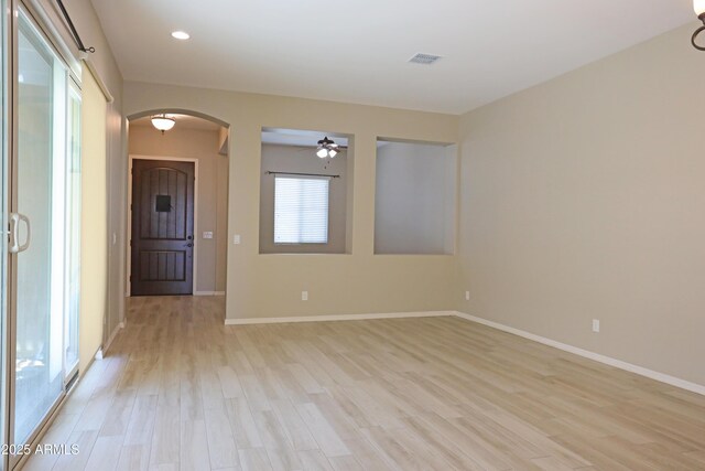 2811 S Jeffry St, Gilbert, AZ 85295 - unfurnished room featuring ceiling fan, arched walkways, light wood-style flooring, and recessed lighting