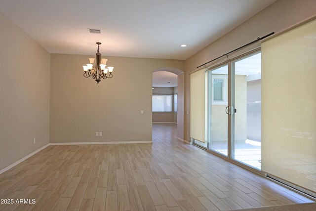 2811 S Jeffry St, Gilbert, AZ 85295 - unfurnished room with arched walkways, light wood-style floors, a chandelier, and recessed lighting