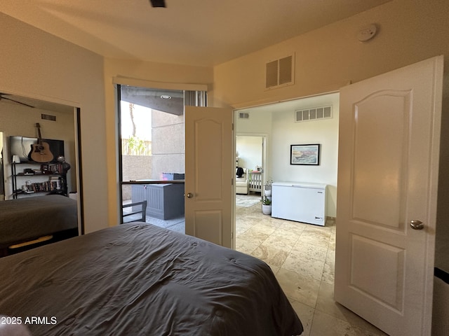 bedroom featuring visible vents and refrigerator