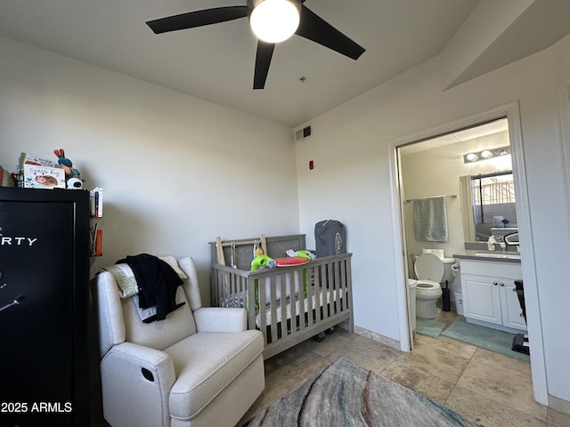 bedroom featuring visible vents, a ceiling fan, a sink, connected bathroom, and baseboards