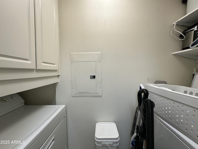 laundry room featuring electric panel, cabinet space, and independent washer and dryer